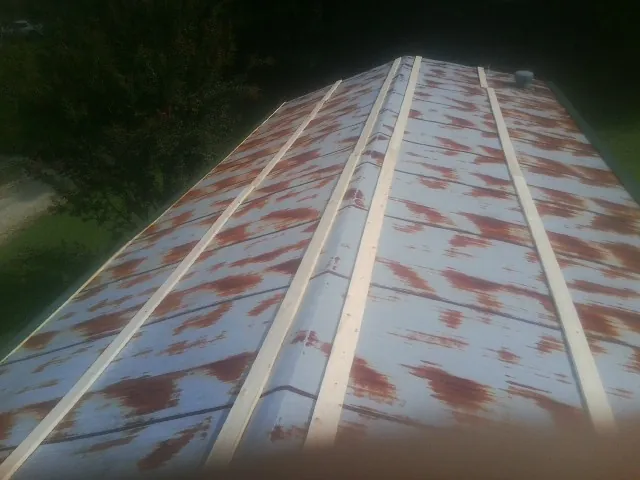Rusted metal roof panels with new wood purlins before replacement — Storm Damage Roof Repair in Landisburg by Roofing Brothers