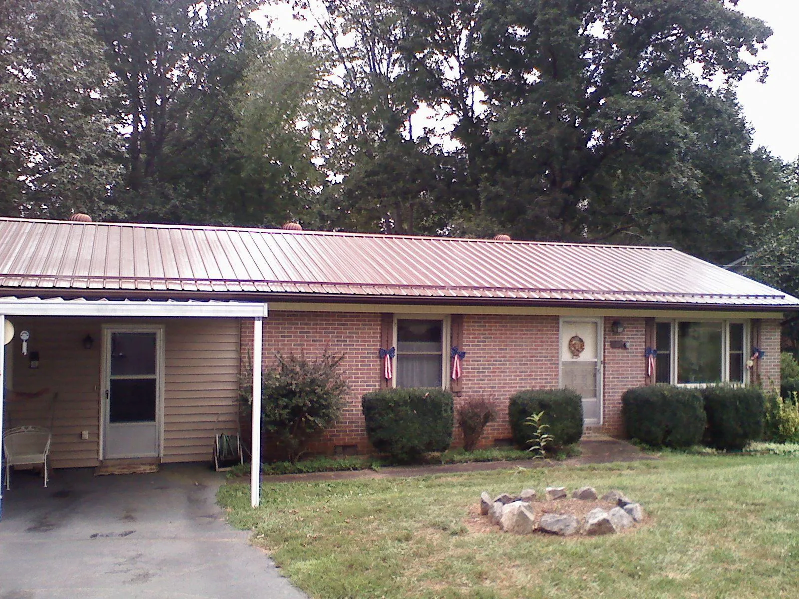 Bronze metal roof and carport on a brick ranch home — Roof Repair work by our crew in Landisburg